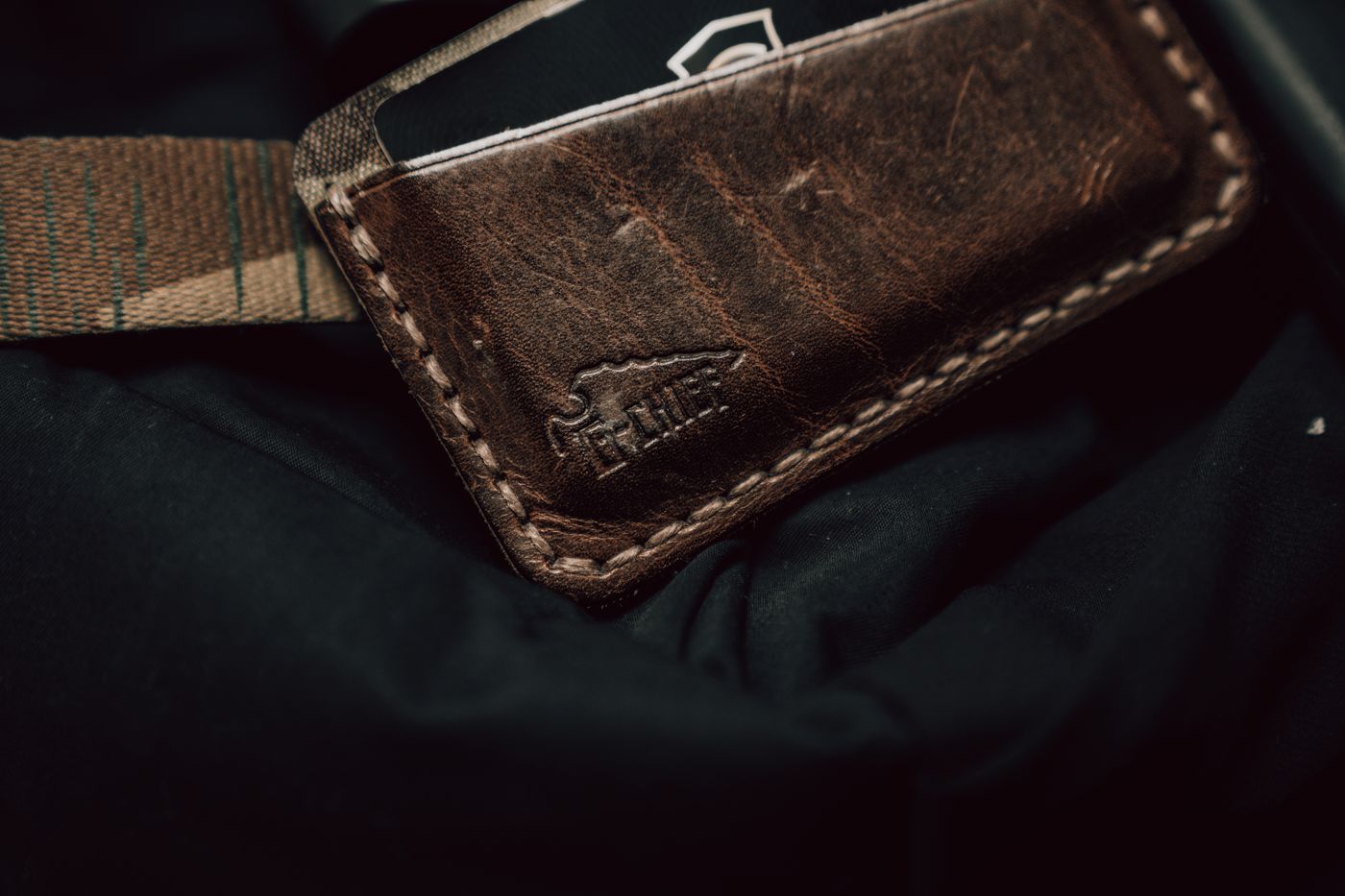 Leather EDC wallet emptied out on a table
